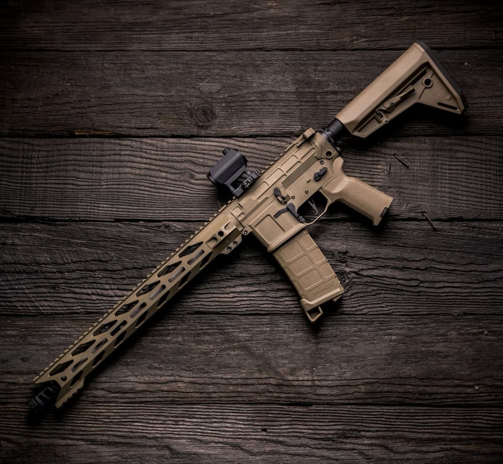 A custom rifle build resting on a wooden table